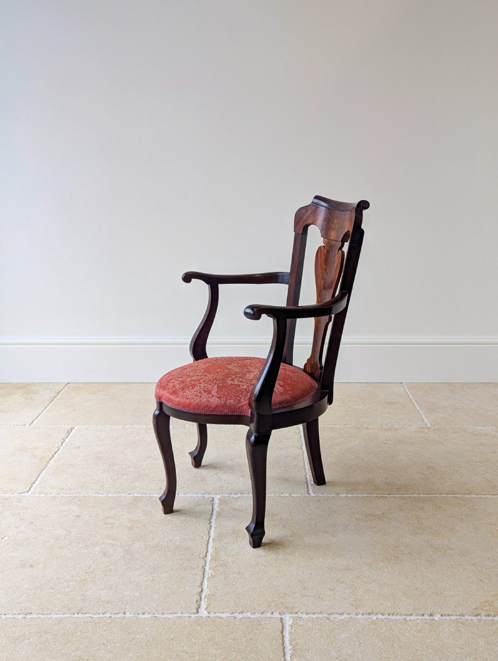 An antique mid-18th century Georgian open armchair crafted from dark mahogany wood featuring a shaped back splat, curved armrests, cabriole front legs, and a red patterned fabric seat. View X