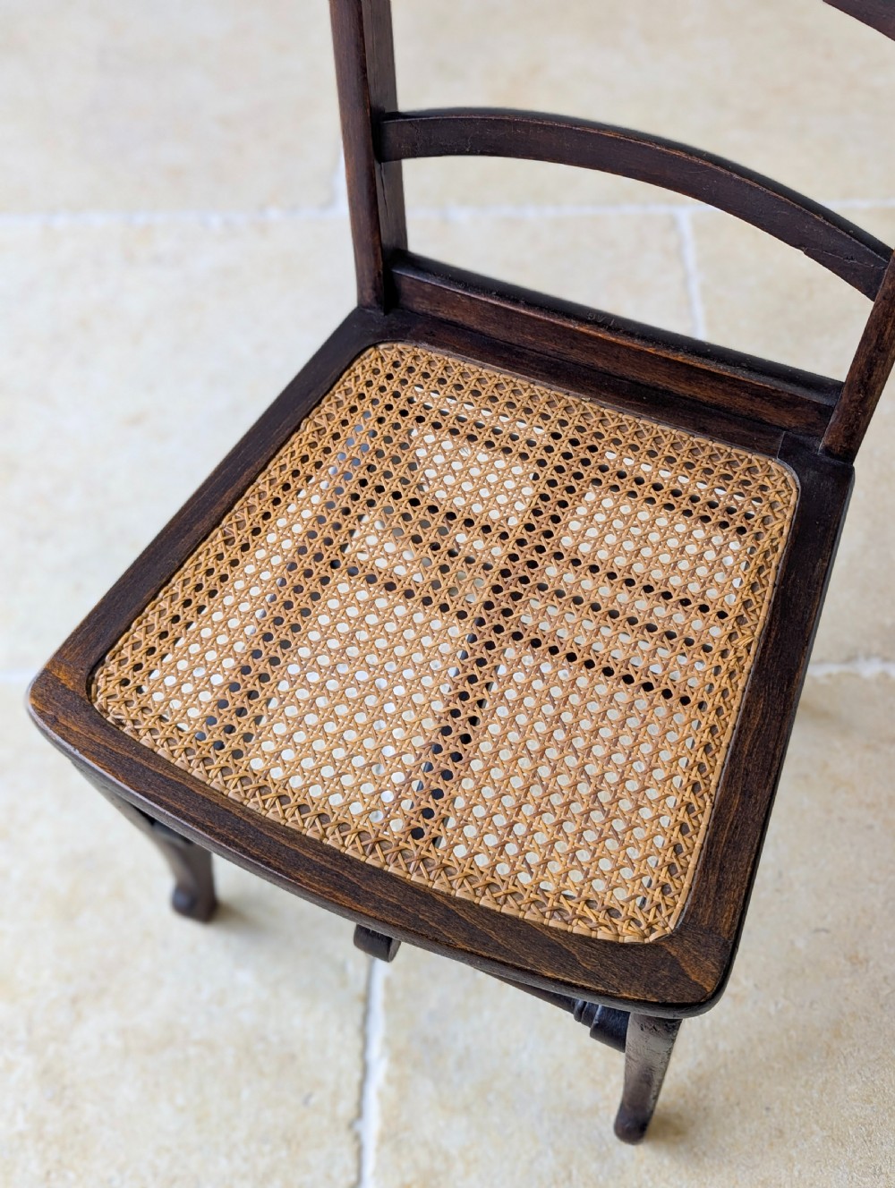 A Victorian dark wood folding campaign chair featuring a triple ladder back, a woven cane seat, and hinged folding legs. View XIII