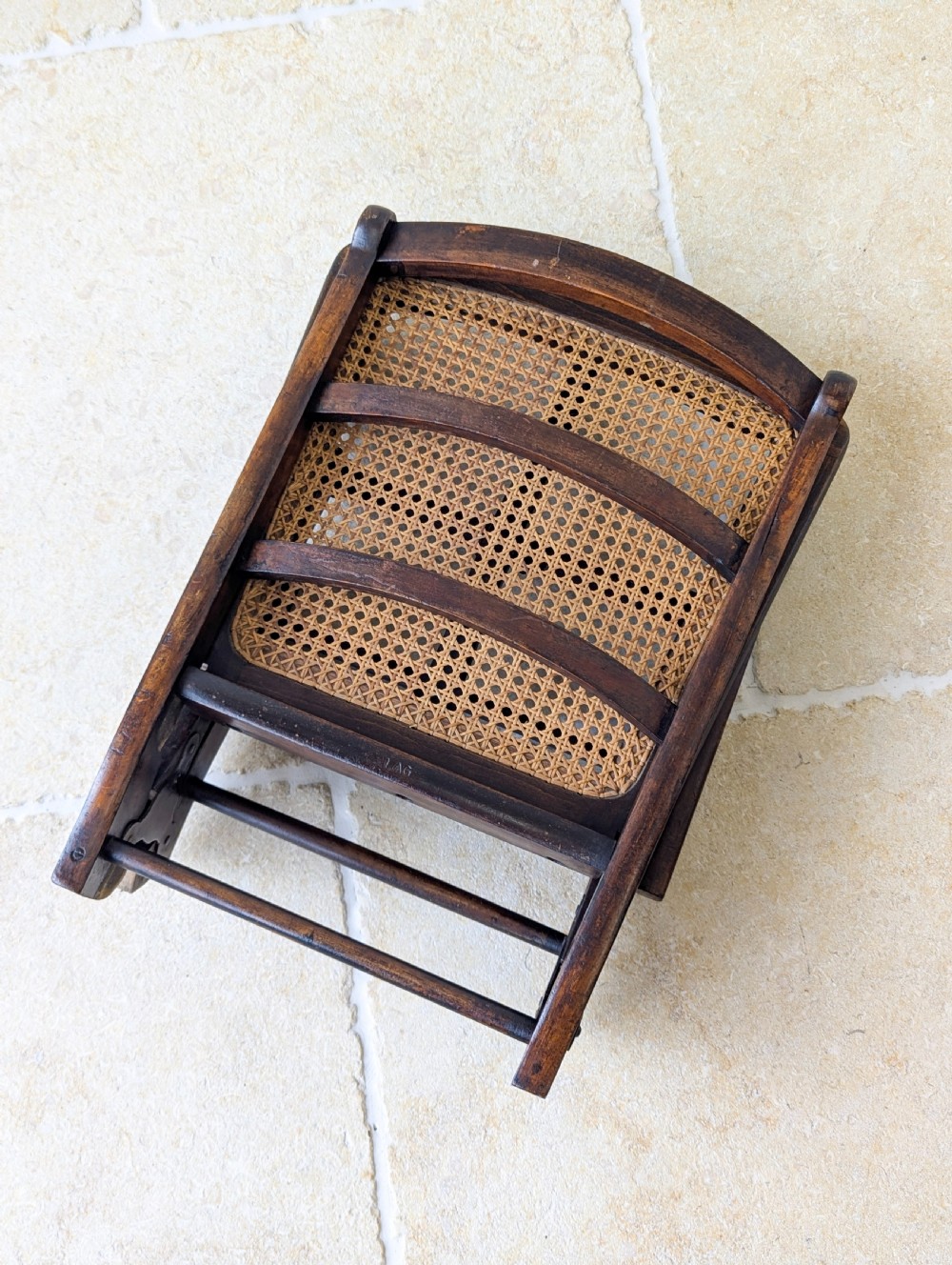 A Victorian dark wood folding campaign chair featuring a triple ladder back, a woven cane seat, and hinged folding legs. View XIV