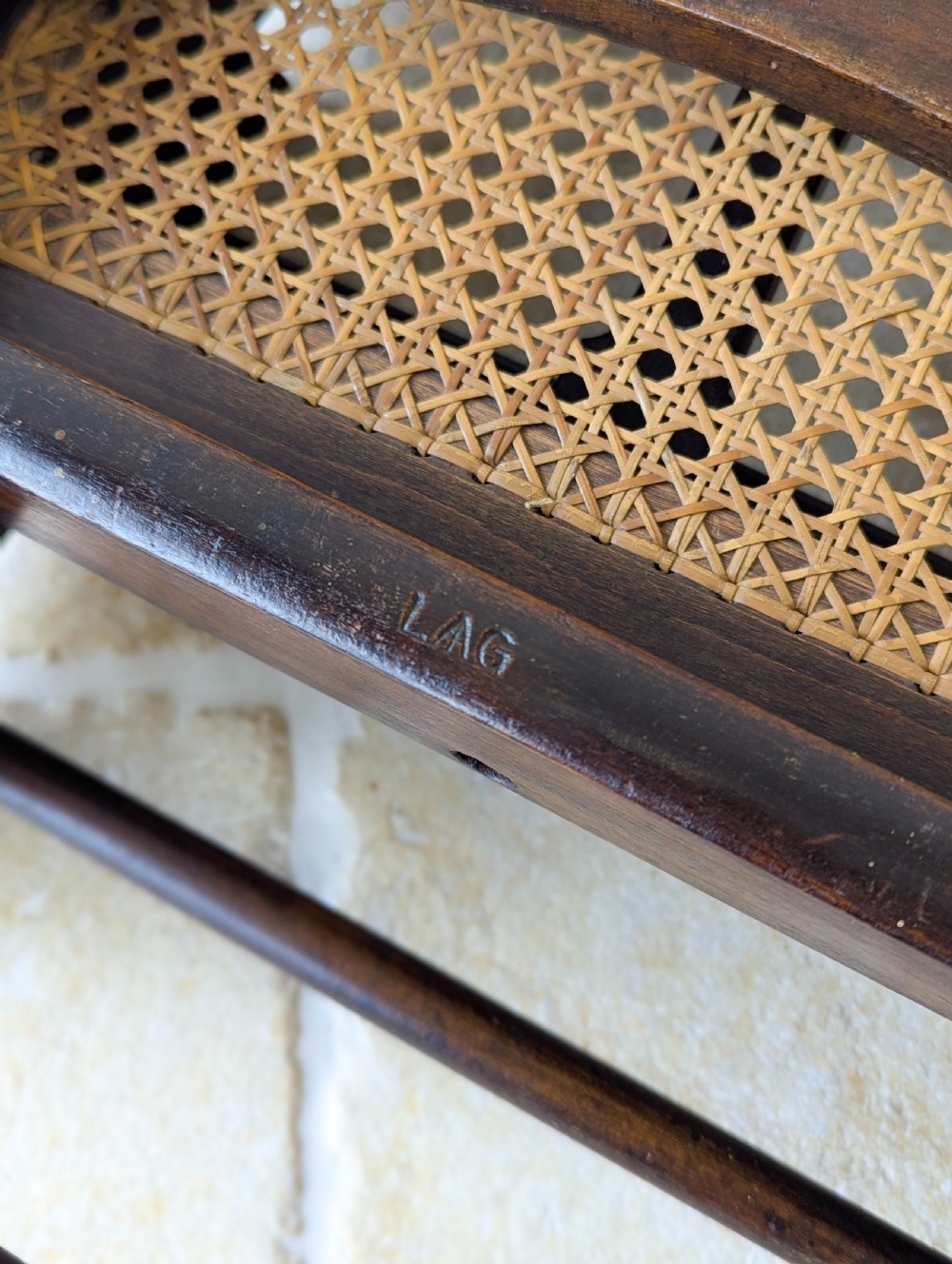A Victorian dark wood folding campaign chair featuring a triple ladder back, a woven cane seat, and hinged folding legs. View XVII