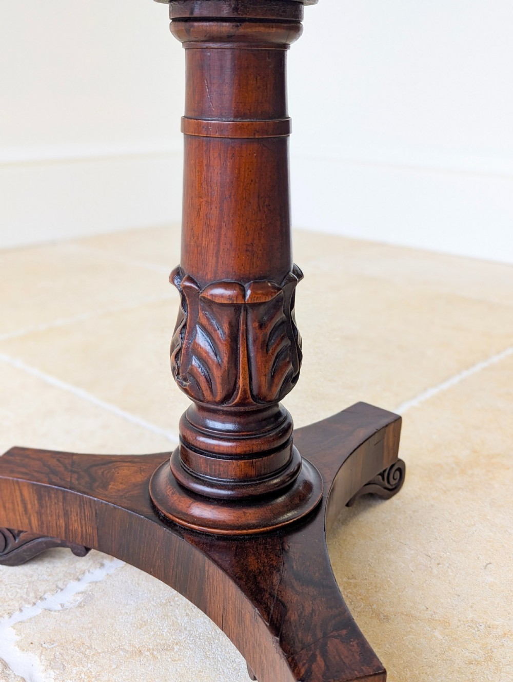 A William IV rosewood adjustable piano stool featuring a circular floral needlepoint seat with burgundy velvet trim, supported by a carved pedestal and triform base. View II