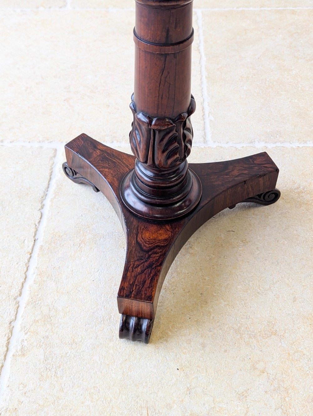 A William IV rosewood adjustable piano stool featuring a circular floral needlepoint seat with burgundy velvet trim, supported by a carved pedestal and triform base. View VI