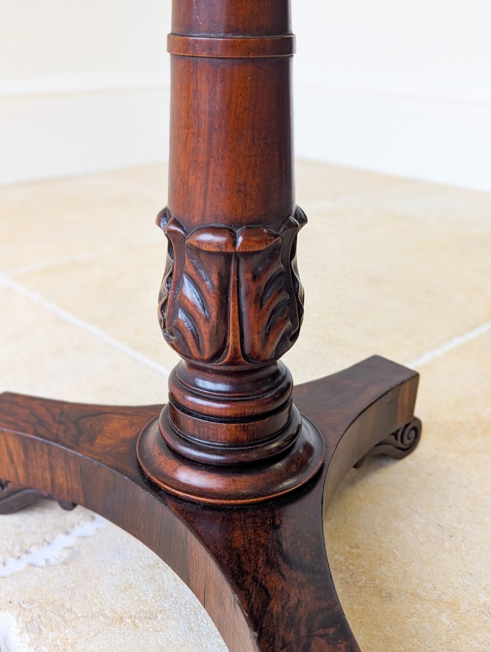 A William IV rosewood adjustable piano stool featuring a circular floral needlepoint seat with burgundy velvet trim, supported by a carved pedestal and triform base. View XII