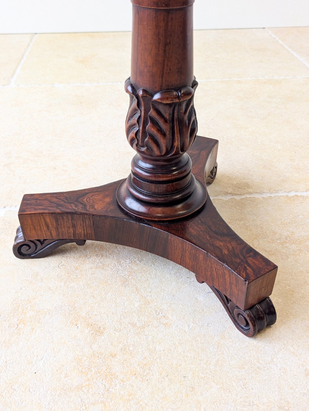 A William IV rosewood adjustable piano stool featuring a circular floral needlepoint seat with burgundy velvet trim, supported by a carved pedestal and triform base. View XVIII