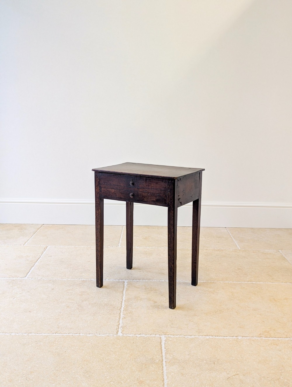An antique Georgian dark oak work table featuring two drawers, straight square legs, and a rectangular top surface. View III