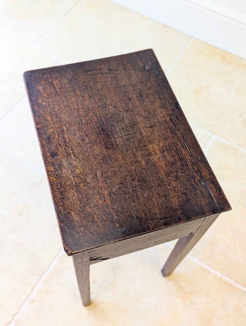 An antique Georgian dark oak work table featuring two drawers, straight square legs, and a rectangular top surface. View VI