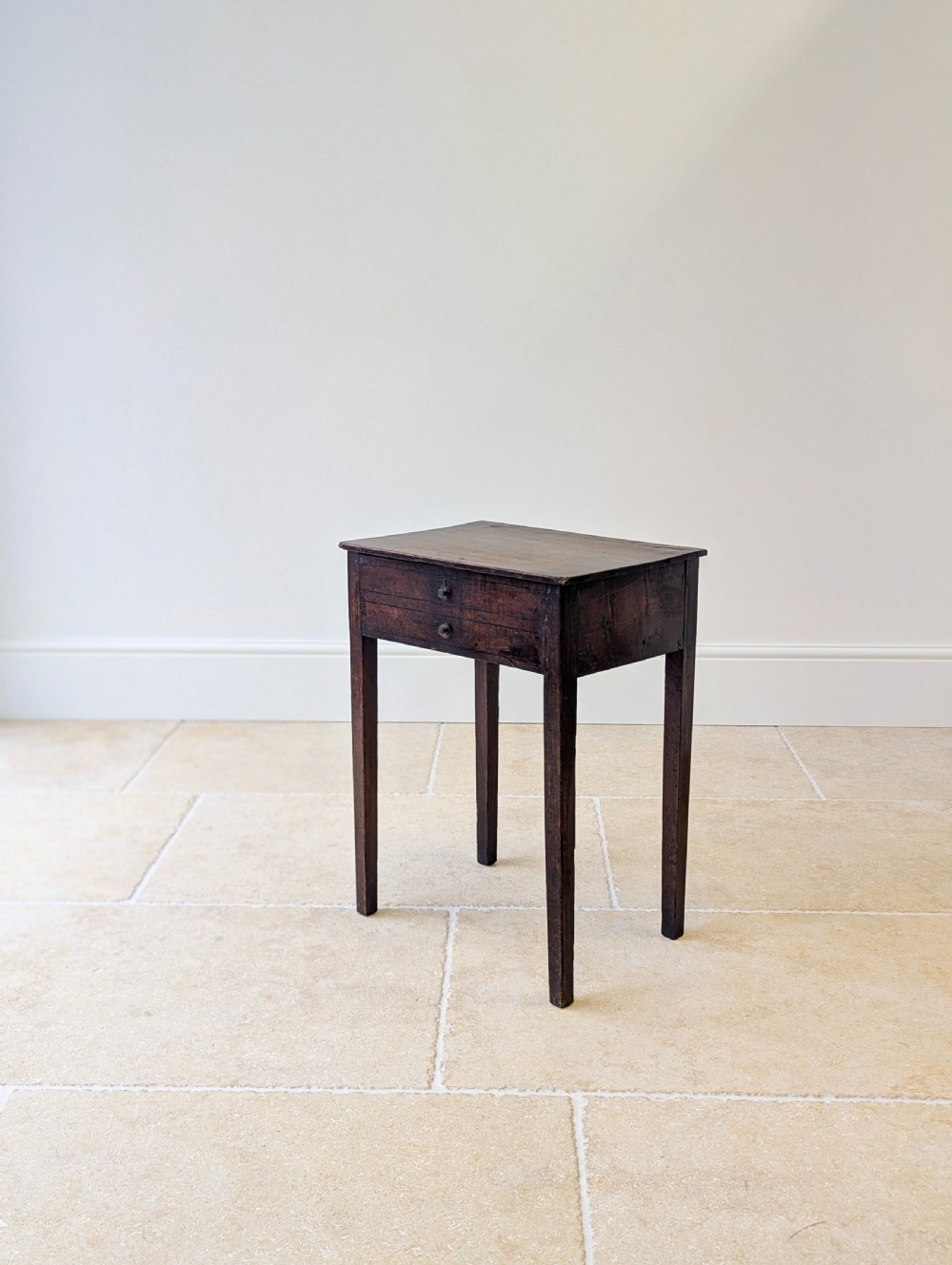 An antique Georgian dark oak work table featuring two drawers, straight square legs, and a rectangular top surface. View VII