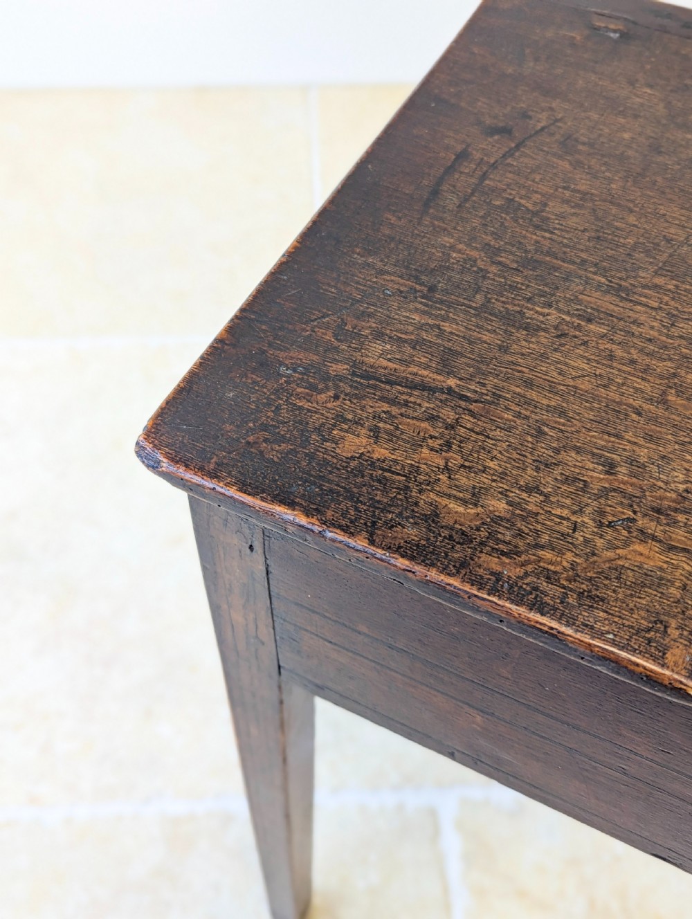 An antique Georgian dark oak work table featuring two drawers, straight square legs, and a rectangular top surface. View X