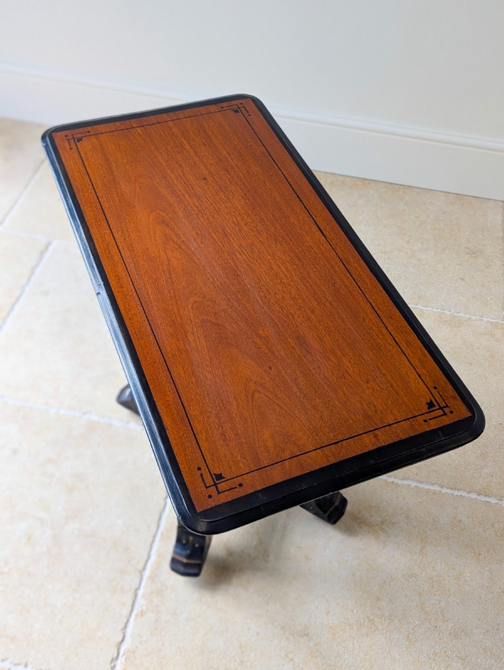 An antique Victorian ebonised and gilt card table with turned twin pedestals and a central finial stretcher. View III