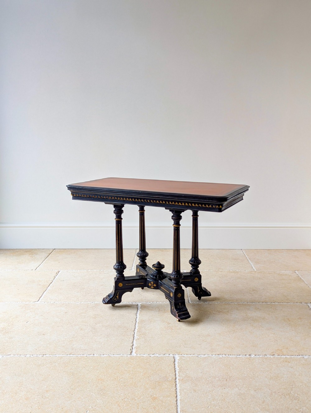 An antique Victorian ebonised and gilt card table with turned twin pedestals and a central finial stretcher. View VII