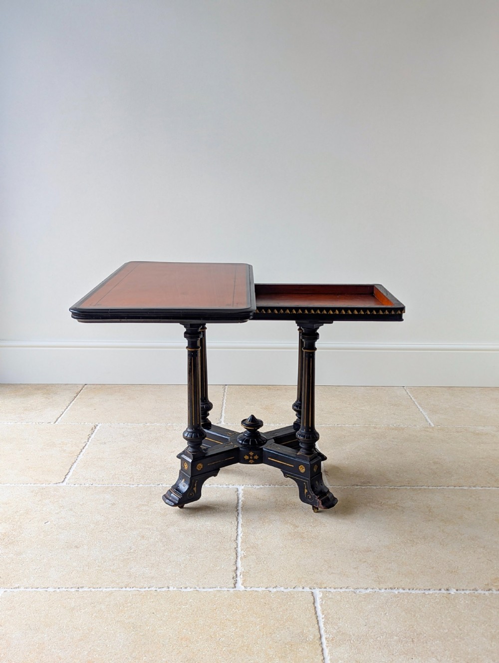 An antique Victorian ebonised and gilt card table with turned twin pedestals and a central finial stretcher. View IX