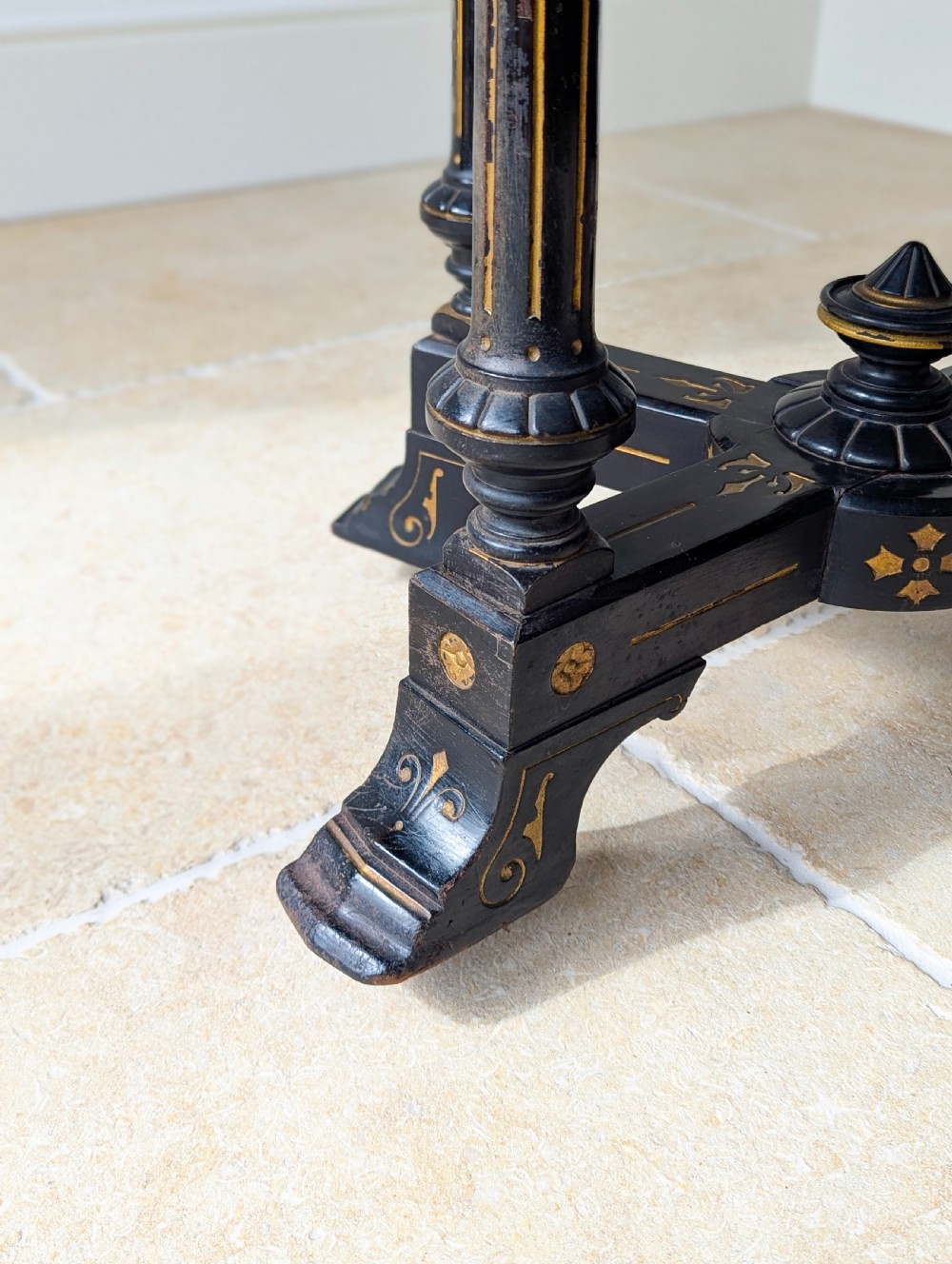 An antique Victorian ebonised and gilt card table with turned twin pedestals and a central finial stretcher. View XI