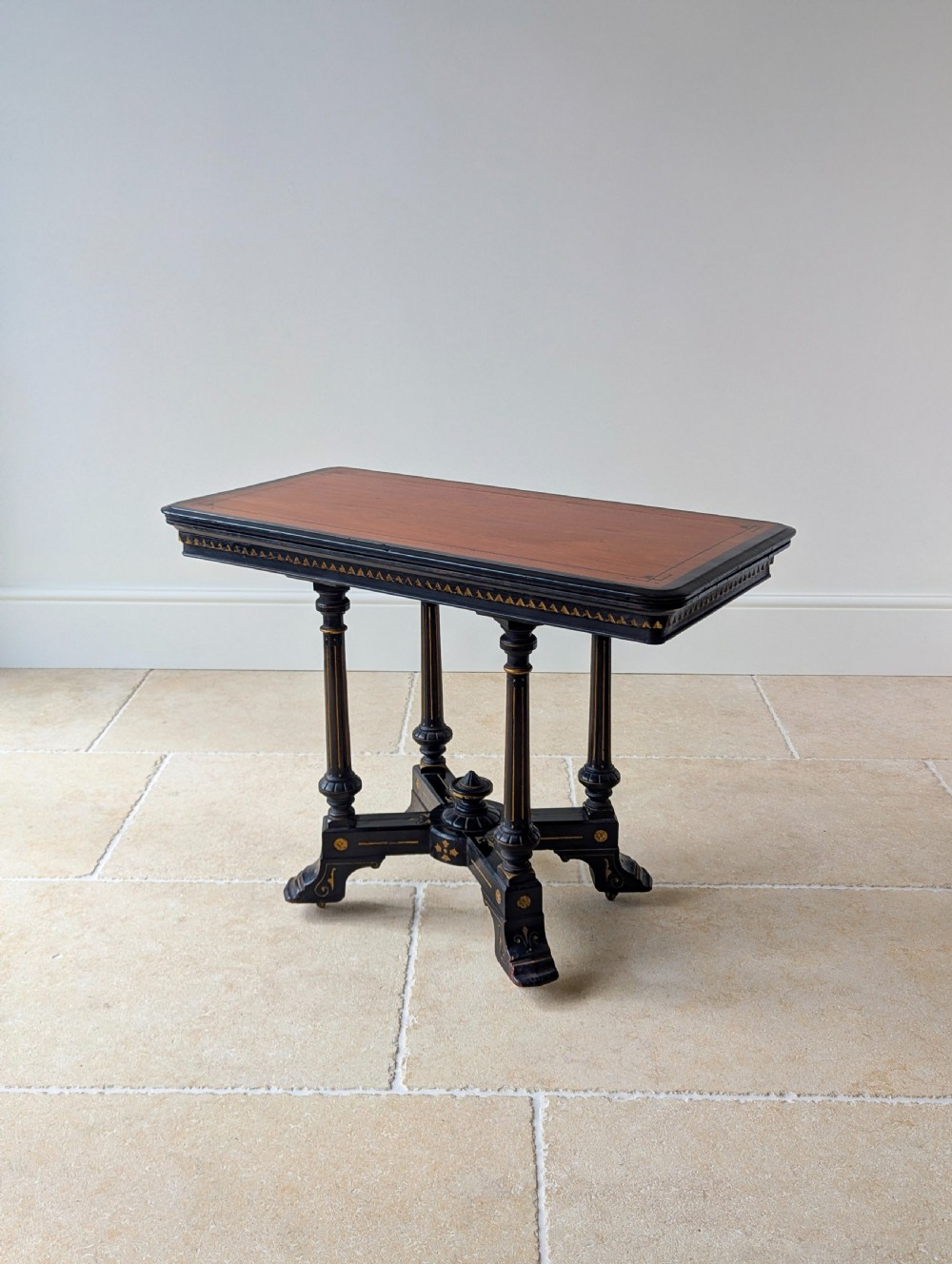 An antique Victorian ebonised and gilt card table with turned twin pedestals and a central finial stretcher. View XVII