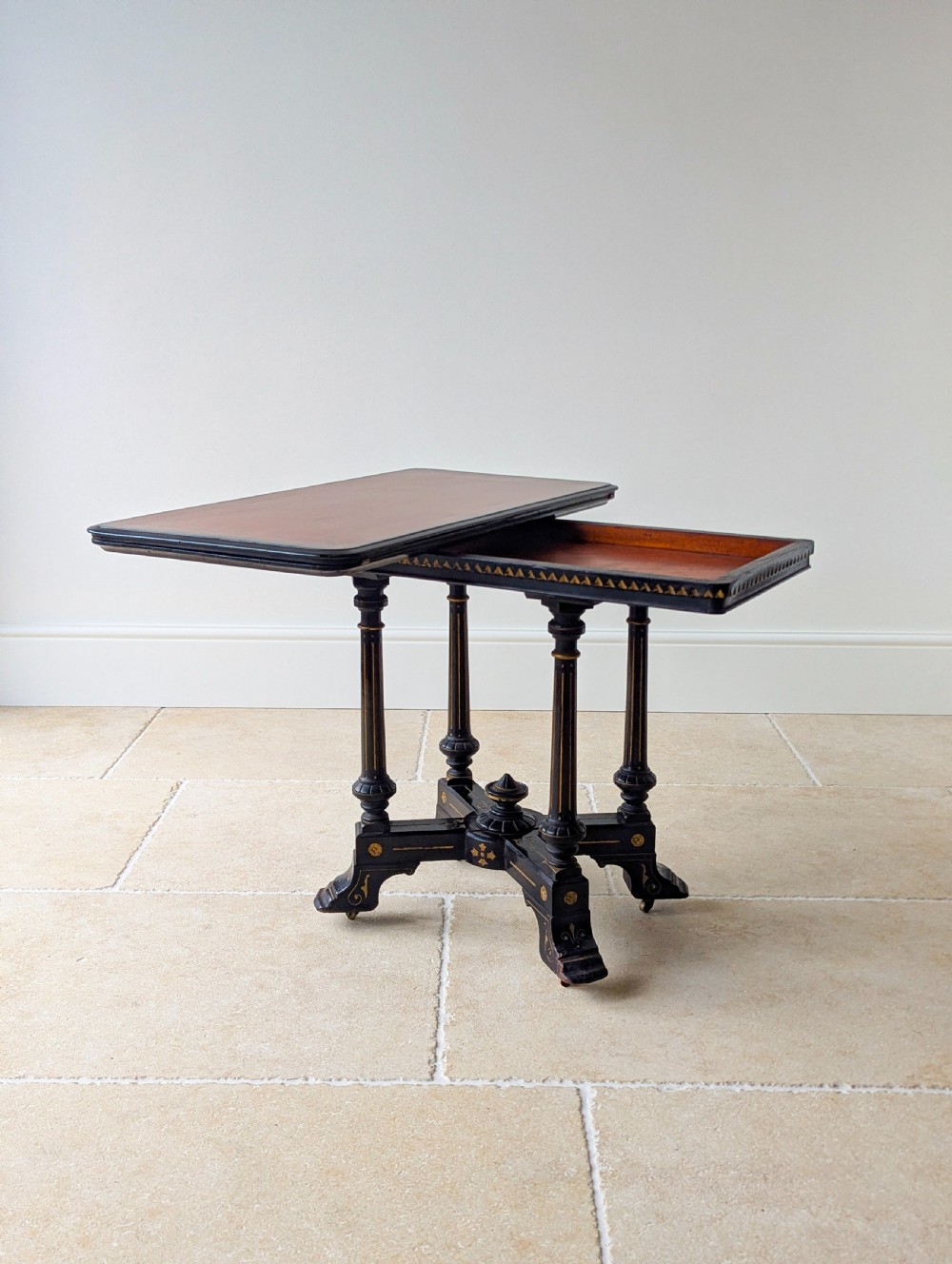 An antique Victorian ebonised and gilt card table with turned twin pedestals and a central finial stretcher. View XVIII