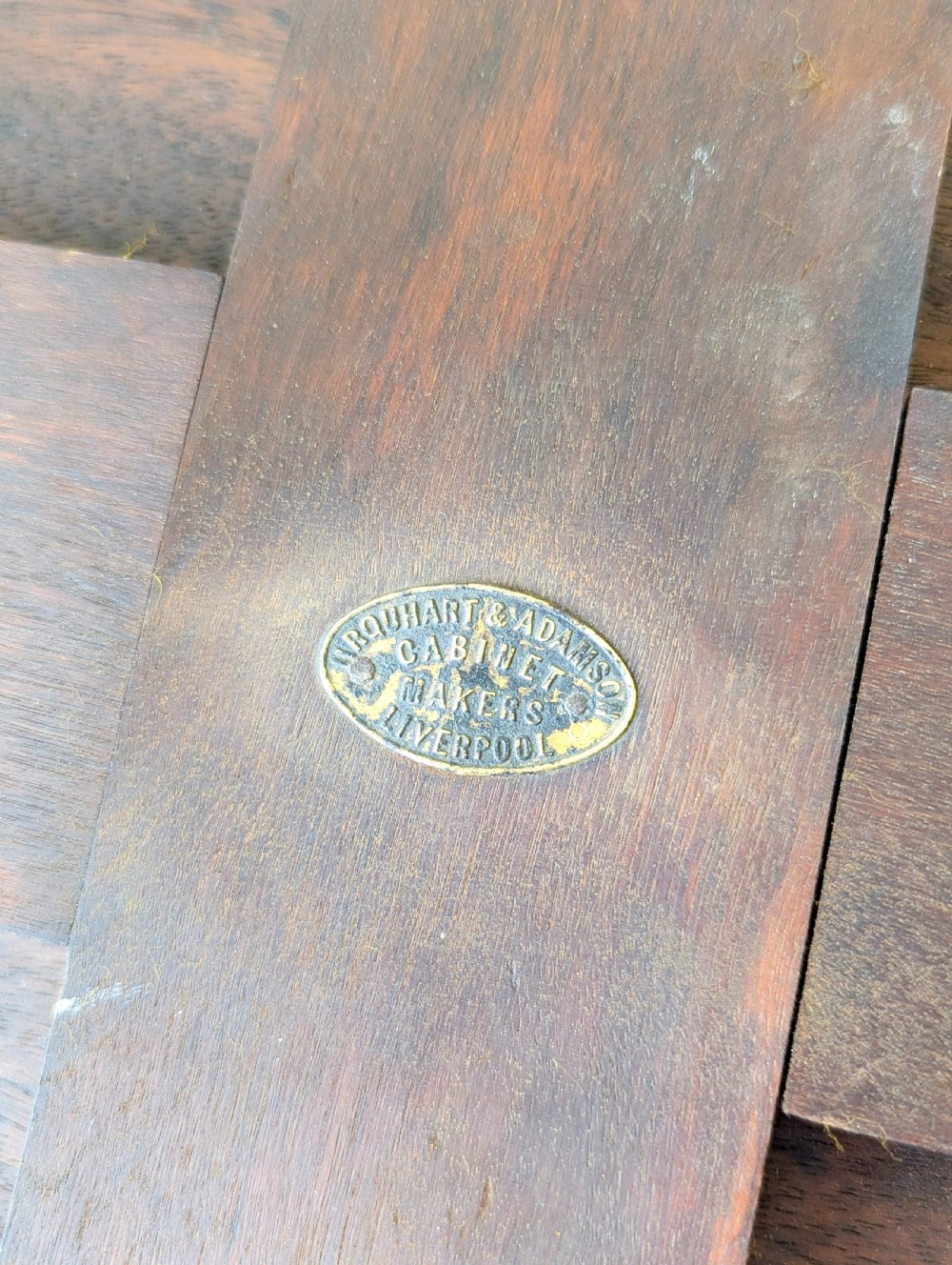 A late Victorian ebonised octagonal occasional table featuring turned legs, gilt highlights, cross stretchers, and brass castors. View XIV