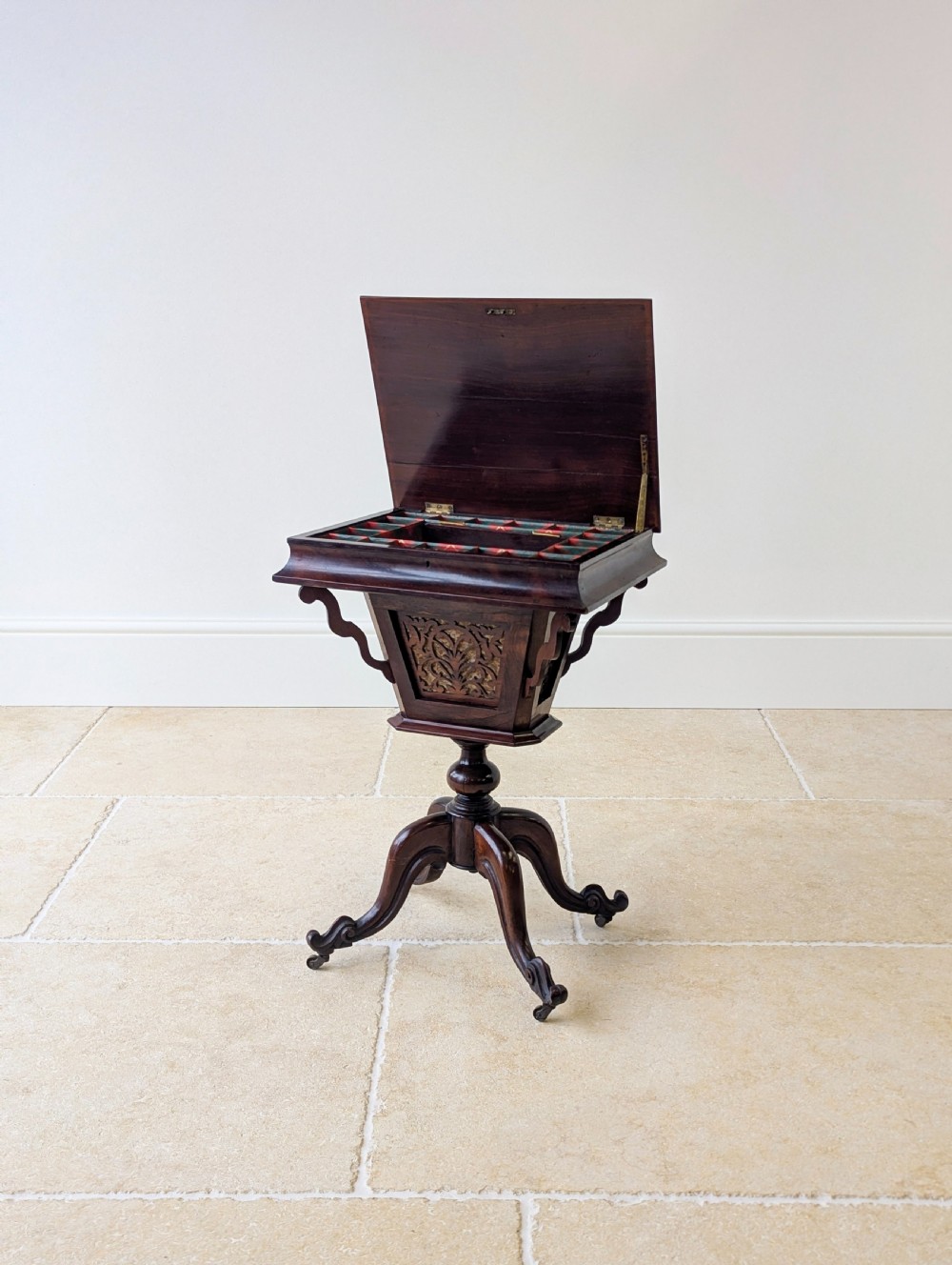 A dark brown rosewood Victorian sewing and reading table featuring an adjustable slanted lid with brass page holders, carved fretwork sides, a turned pedestal column, and four scrolled feet. View XI