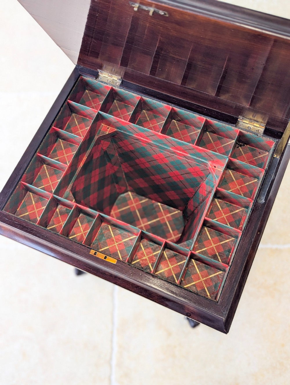 A dark brown rosewood Victorian sewing and reading table featuring an adjustable slanted lid with brass page holders, carved fretwork sides, a turned pedestal column, and four scrolled feet. View XII
