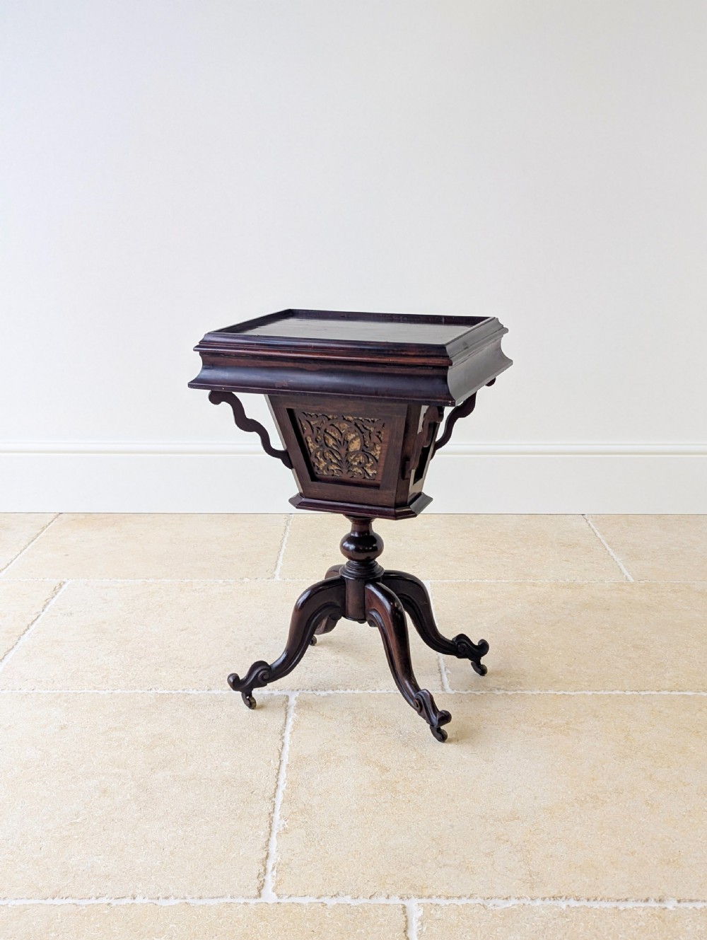 A dark brown rosewood Victorian sewing and reading table featuring an adjustable slanted lid with brass page holders, carved fretwork sides, a turned pedestal column, and four scrolled feet. View XV