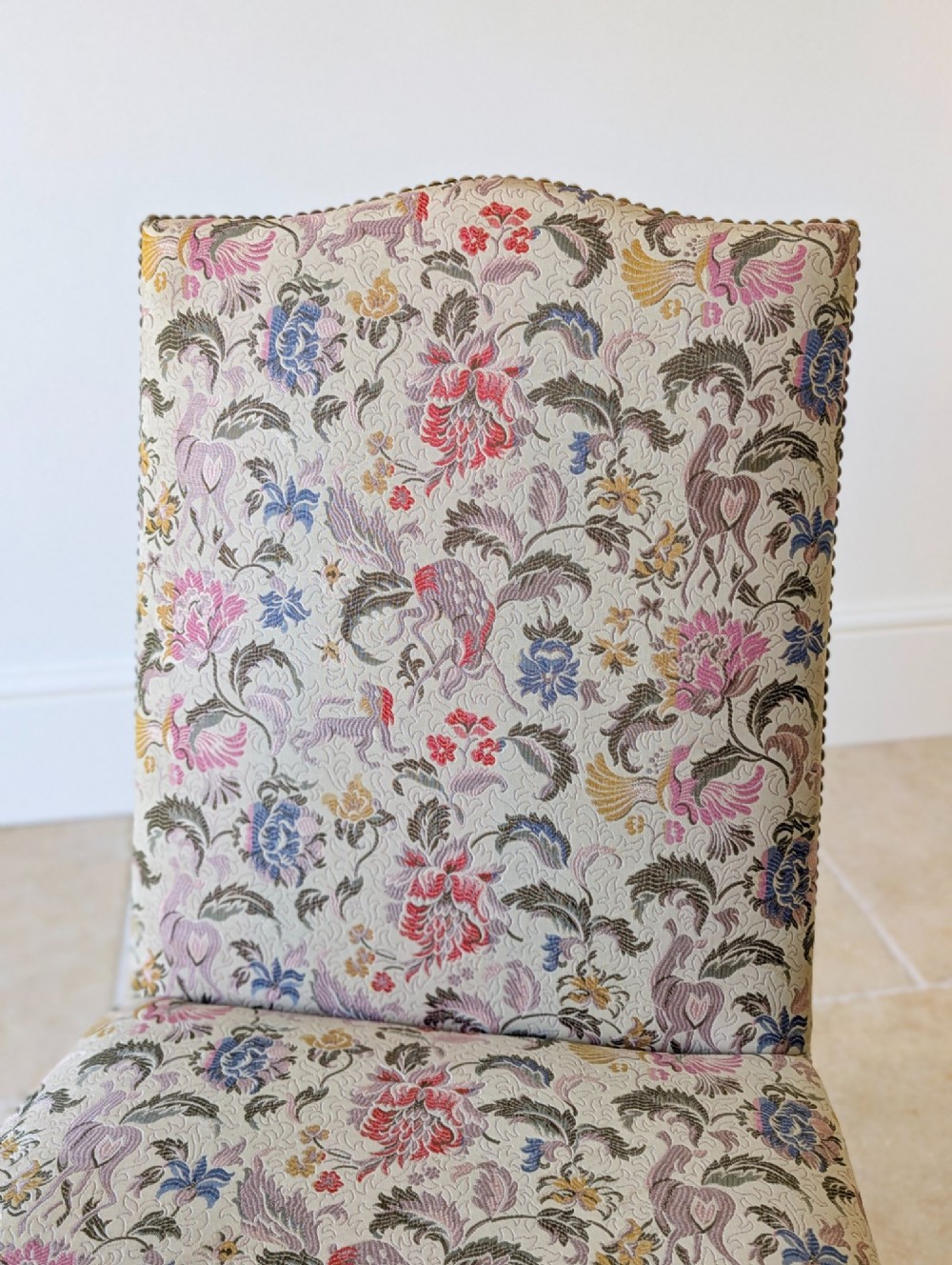 A mid-19th century Victorian side chair with dark mahogany legs on brass castors and dense floral upholstery framed with brass studding. View IV