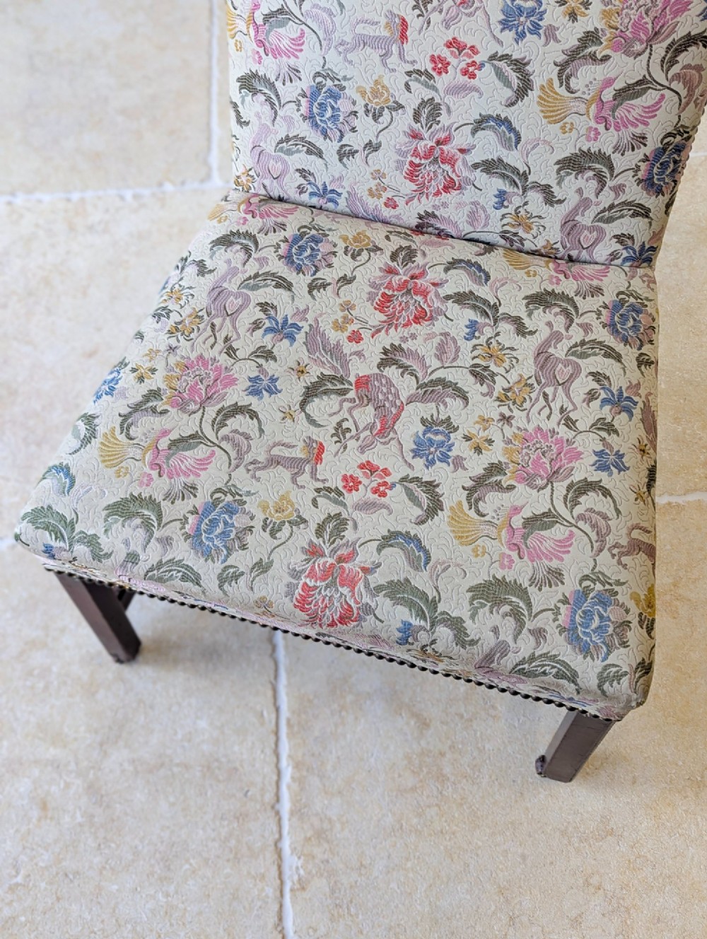 A mid-19th century Victorian side chair with dark mahogany legs on brass castors and dense floral upholstery framed with brass studding. View IX