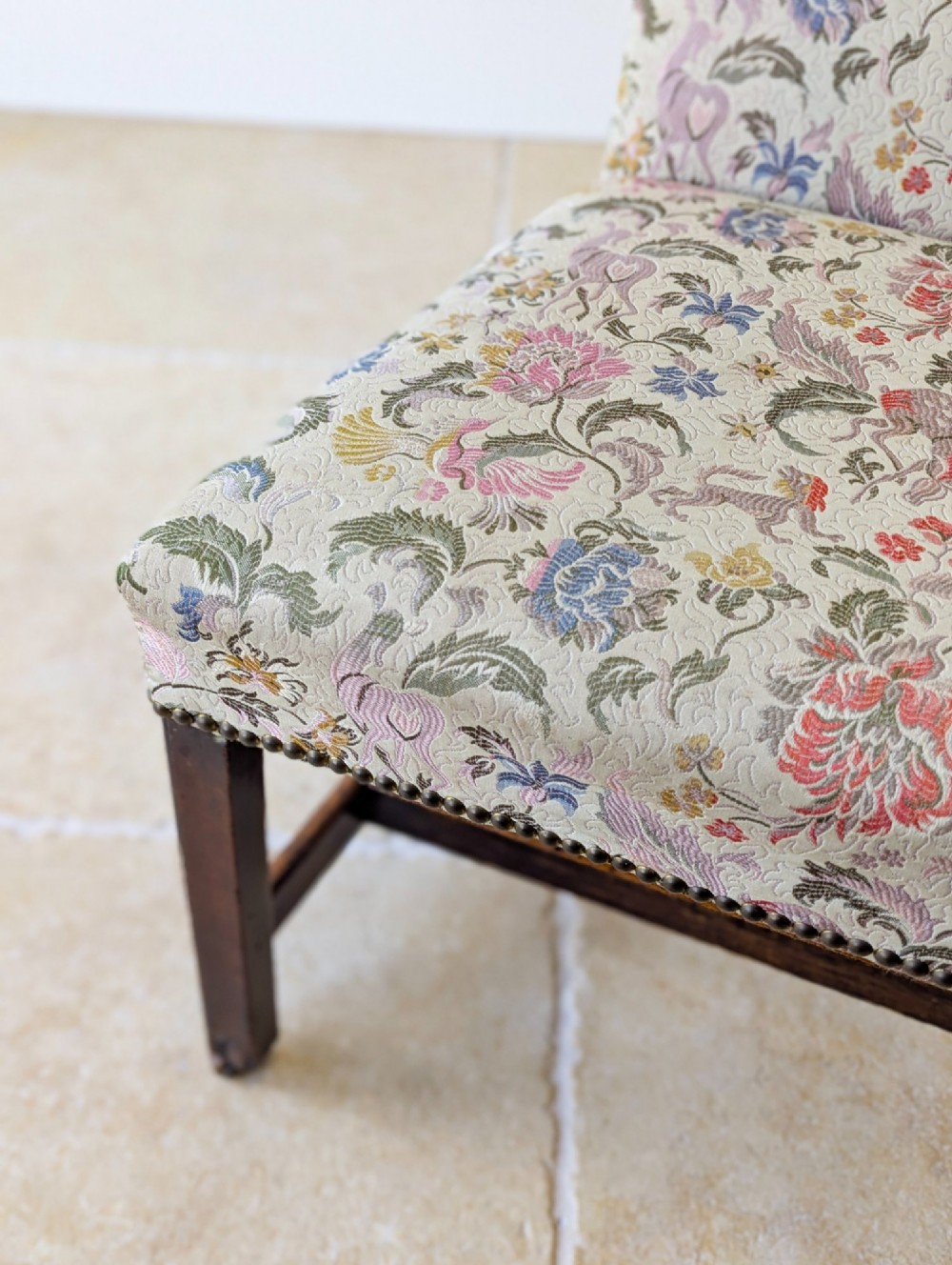 A mid-19th century Victorian side chair with dark mahogany legs on brass castors and dense floral upholstery framed with brass studding. View XIII