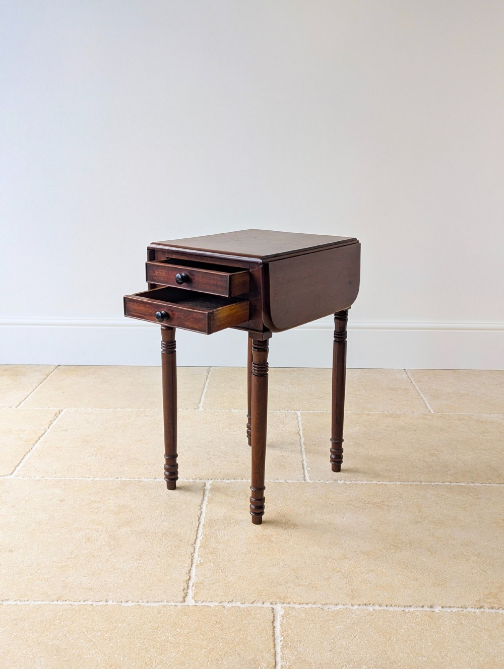 An early Victorian dark mahogany Pembroke work table with two drawers, turned legs, and two extended drop-leaf flaps. View VII