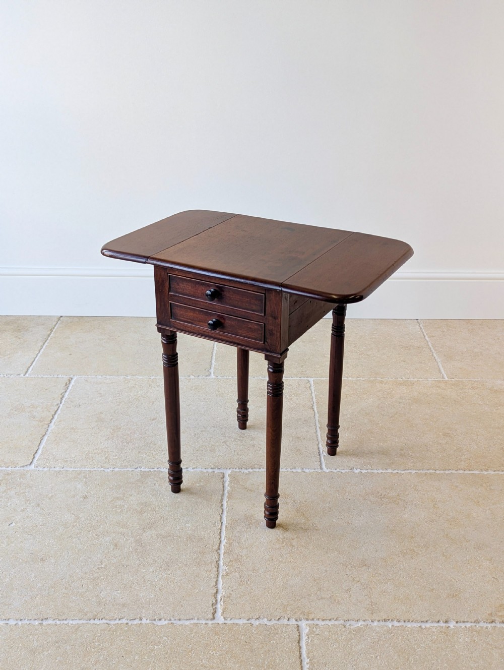 An early Victorian dark mahogany Pembroke work table with two drawers, turned legs, and two extended drop-leaf flaps. View VIII