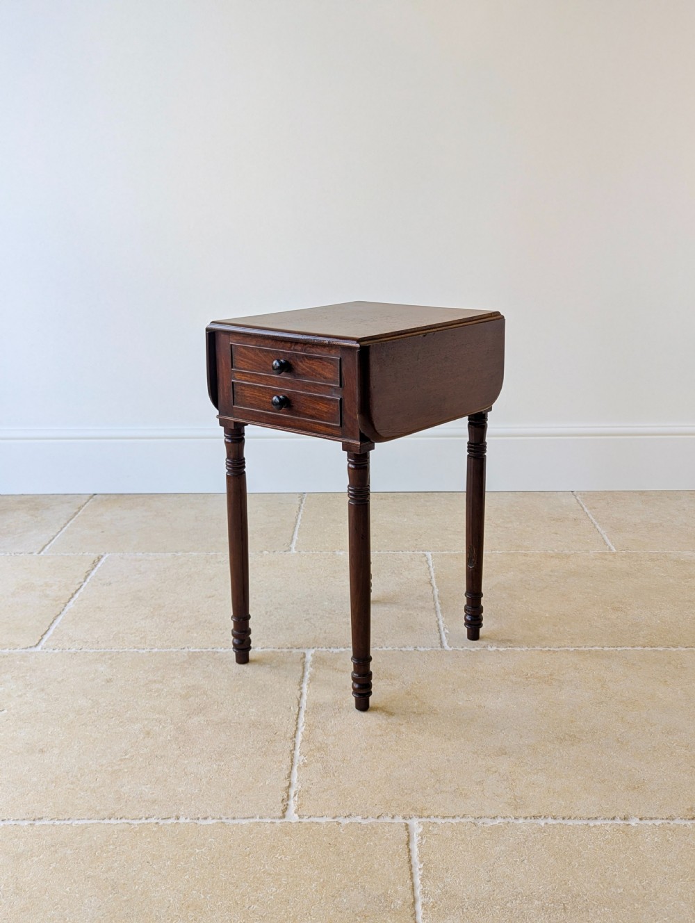 An early Victorian dark mahogany Pembroke work table with two drawers, turned legs, and two extended drop-leaf flaps. View IX