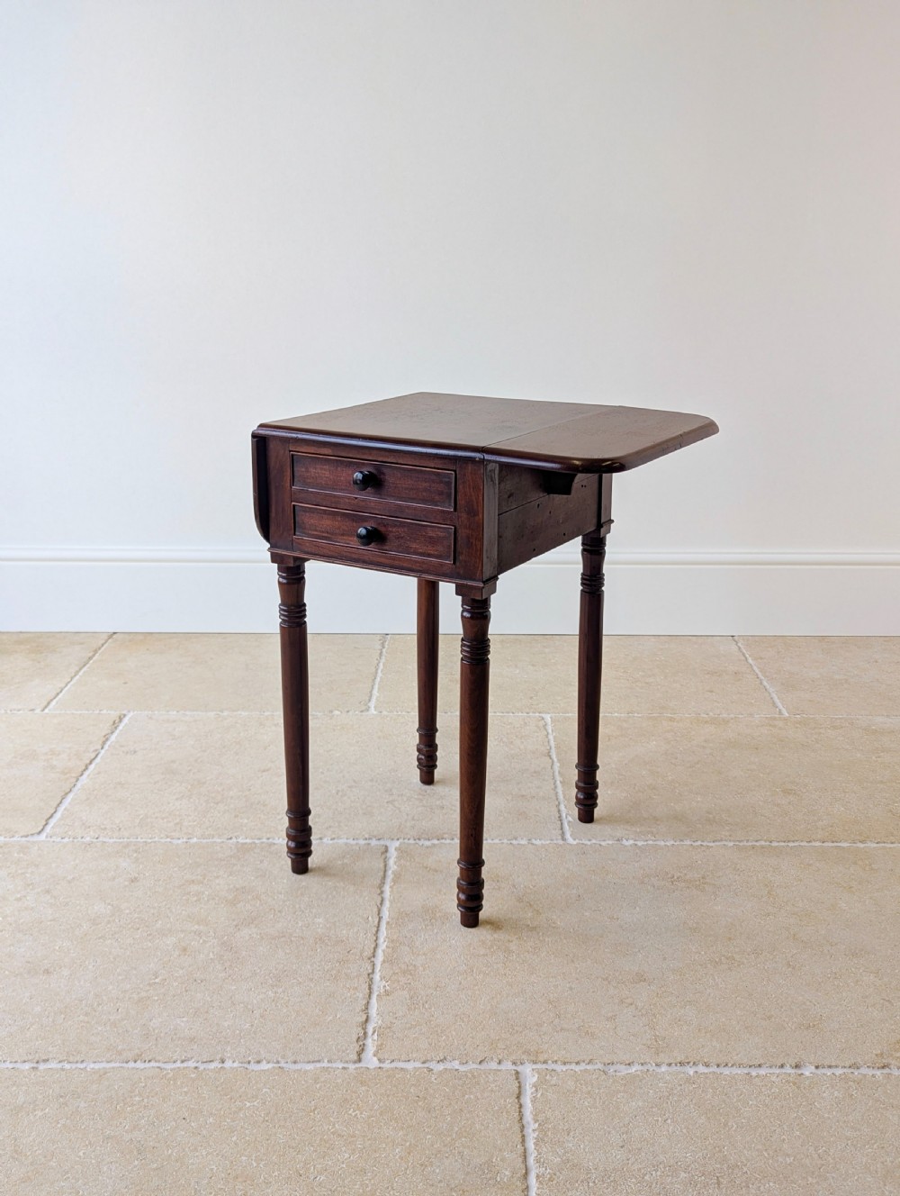 An early Victorian dark mahogany Pembroke work table with two drawers, turned legs, and two extended drop-leaf flaps. View XI