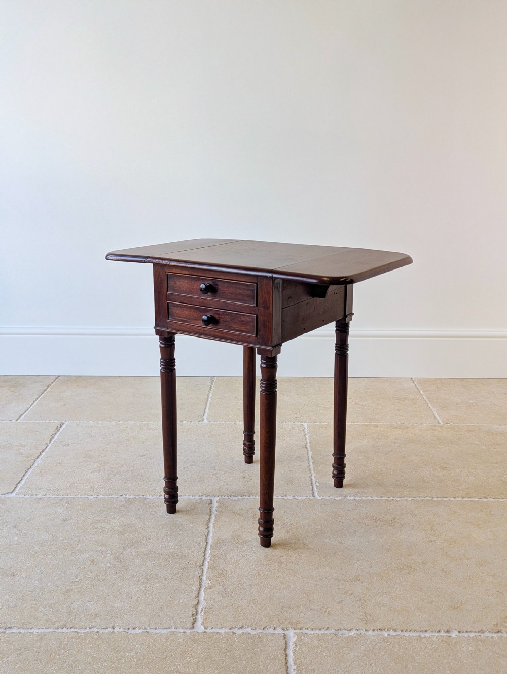 An early Victorian dark mahogany Pembroke work table with two drawers, turned legs, and two extended drop-leaf flaps. View XIII