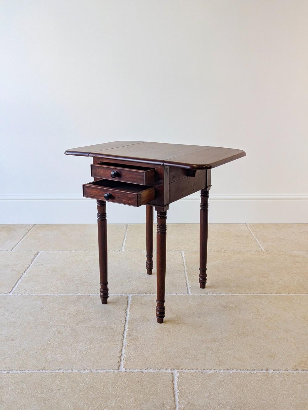 An early Victorian dark mahogany Pembroke work table with two drawers, turned legs, and two extended drop-leaf flaps. View XIV