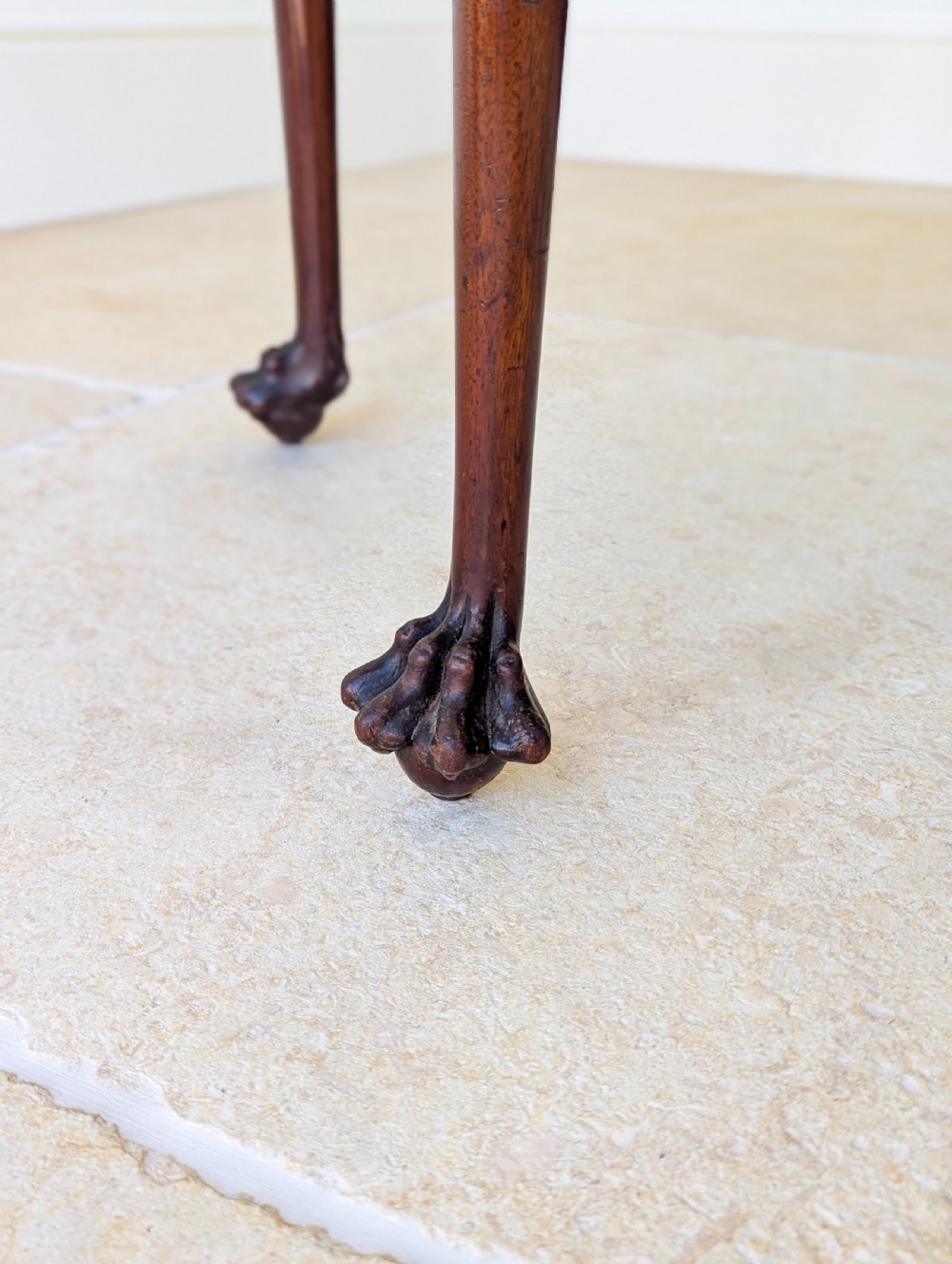 An Edwardian dark mahogany fold-over card table featuring carved cabriole legs, claw and ball feet, and blind fretwork along the apron. View IX