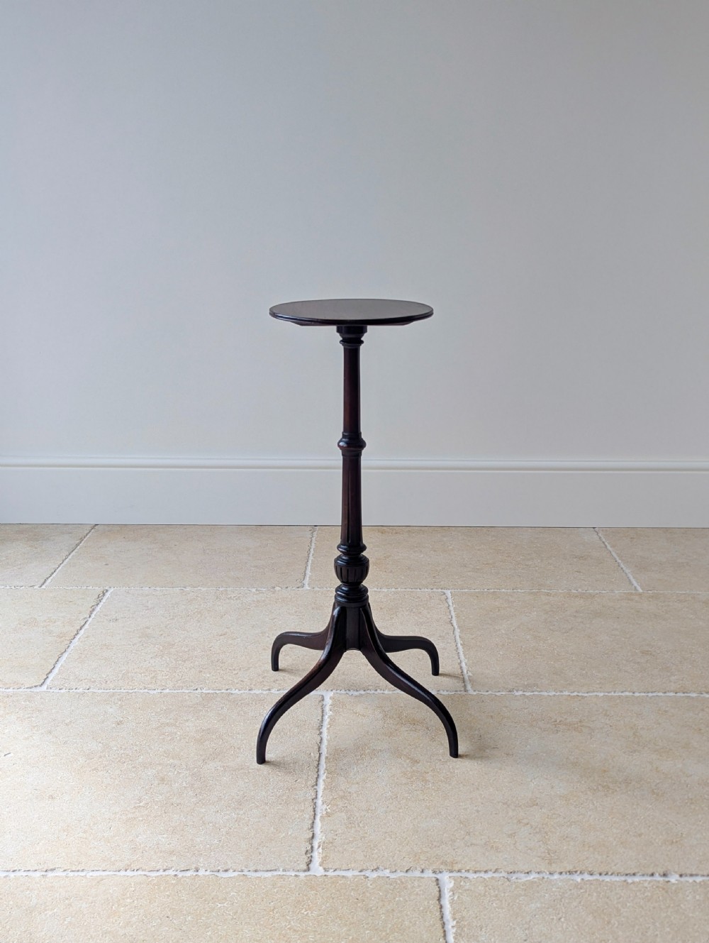 A tall, slender dark walnut torchere featuring a circular flat top, a turned central column, and a sweeping tripod base. View VIII