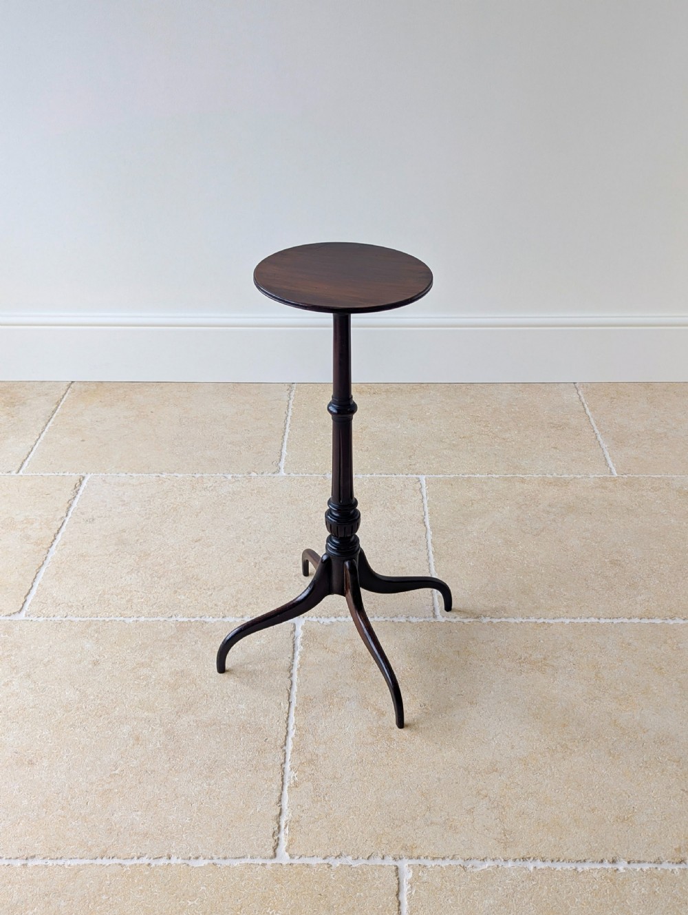 A tall, slender dark walnut torchere featuring a circular flat top, a turned central column, and a sweeping tripod base. View IX