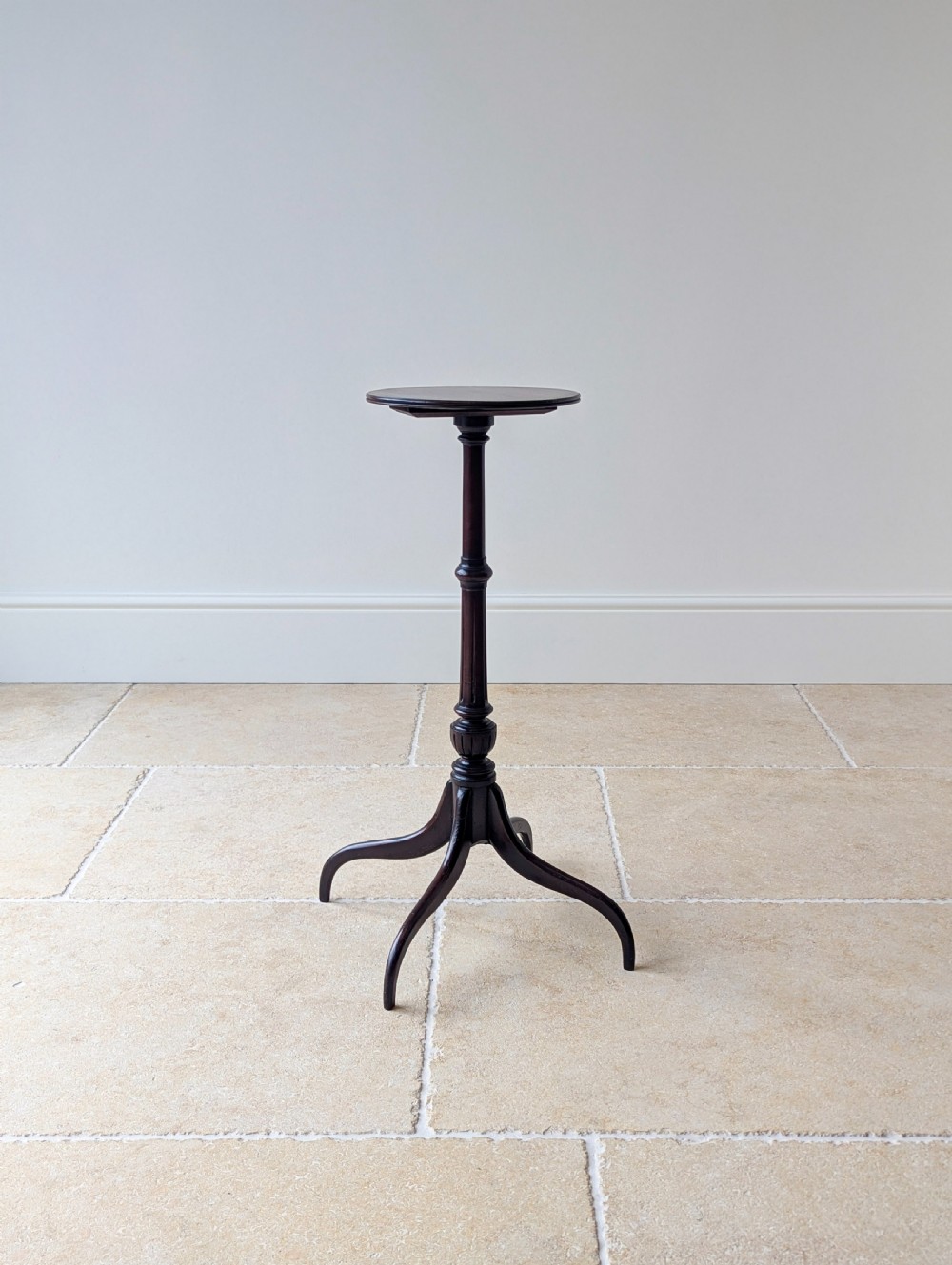 A tall, slender dark walnut torchere featuring a circular flat top, a turned central column, and a sweeping tripod base. View XIV