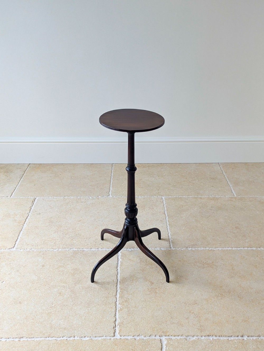 A tall, slender dark walnut torchere featuring a circular flat top, a turned central column, and a sweeping tripod base. View XV