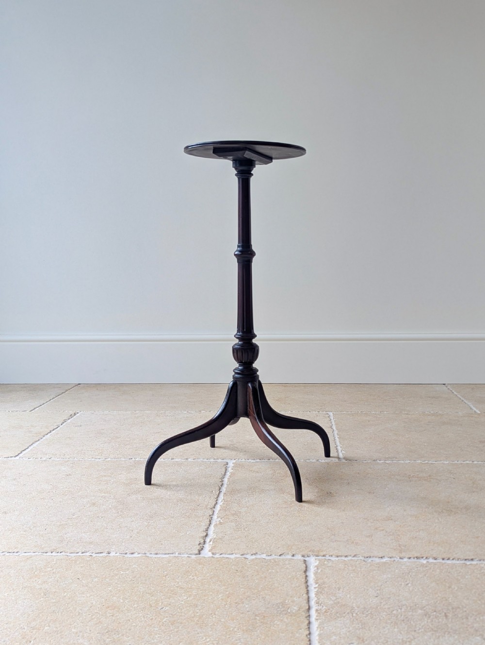 A tall, slender dark walnut torchere featuring a circular flat top, a turned central column, and a sweeping tripod base. View XVIII