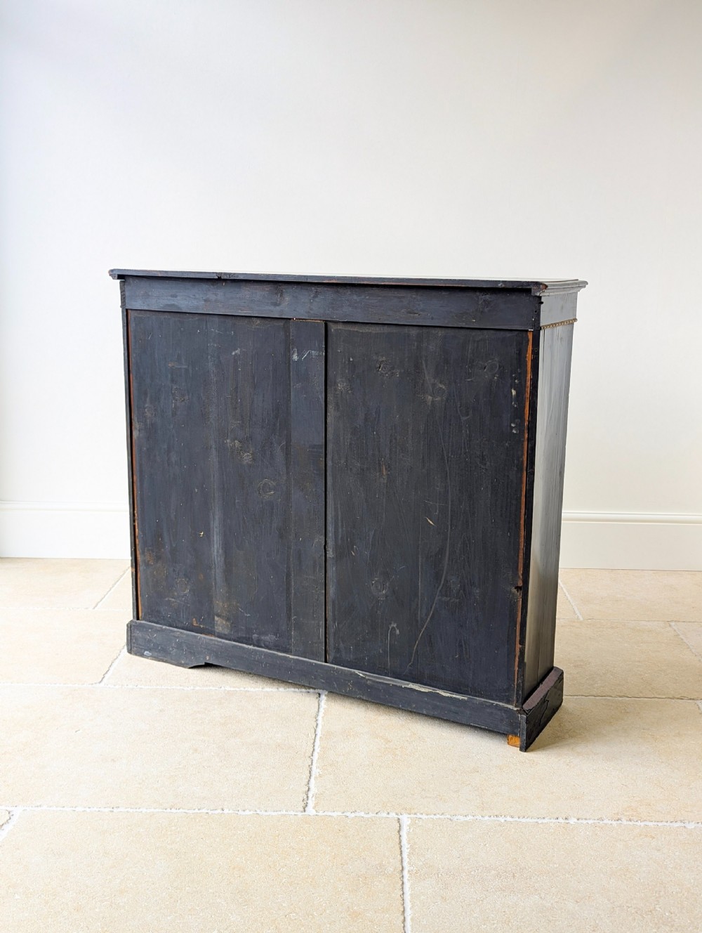 A Victorian ebonised open bookcase with three shelves, gold inlay, and gilt bronze mounts along the side uprights. View XVI