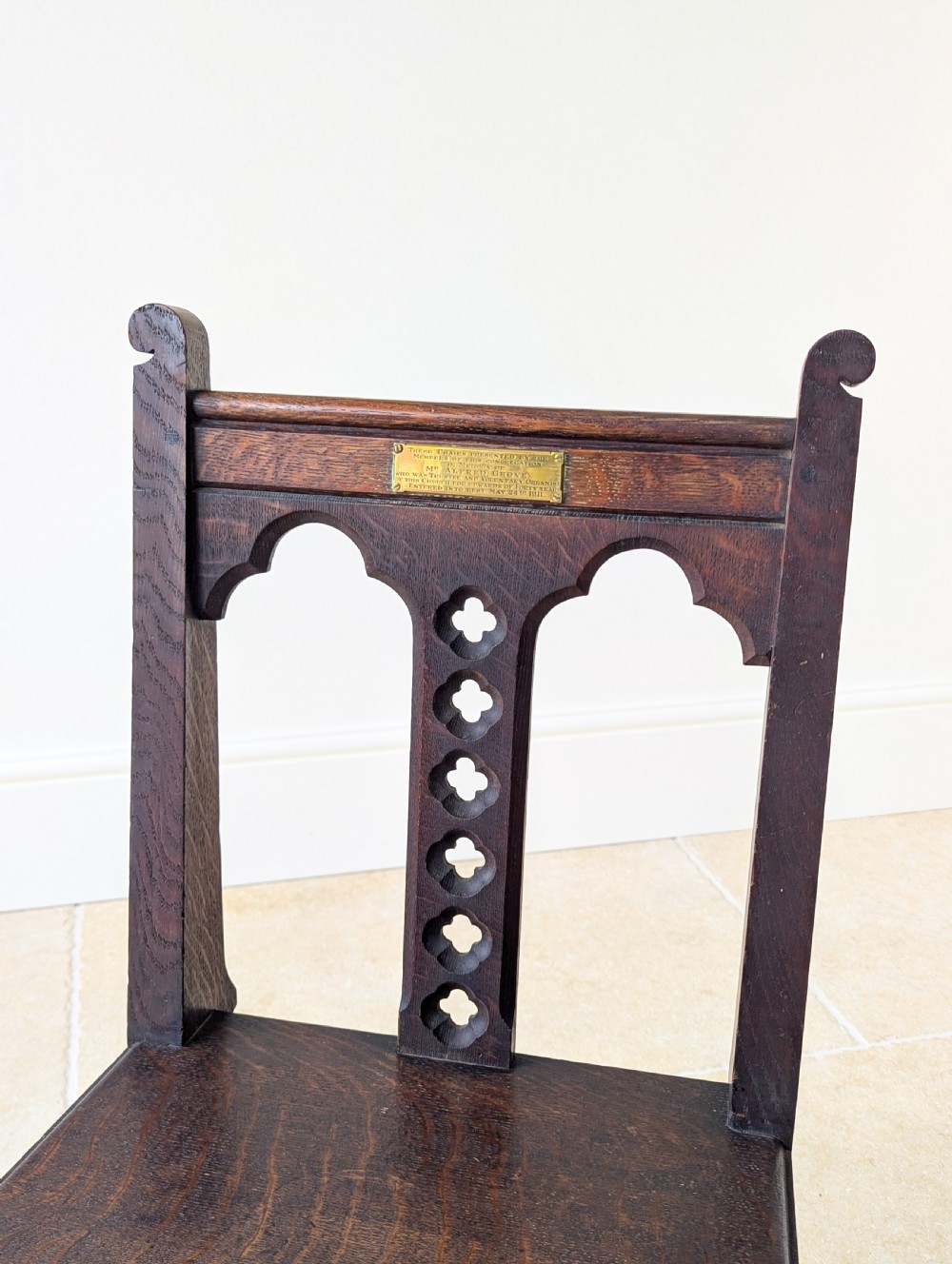A pair of dark oak Edwardian Gothic Revival side chairs displaying trefoil cutouts, pointed arches, and solid square legs. View VI