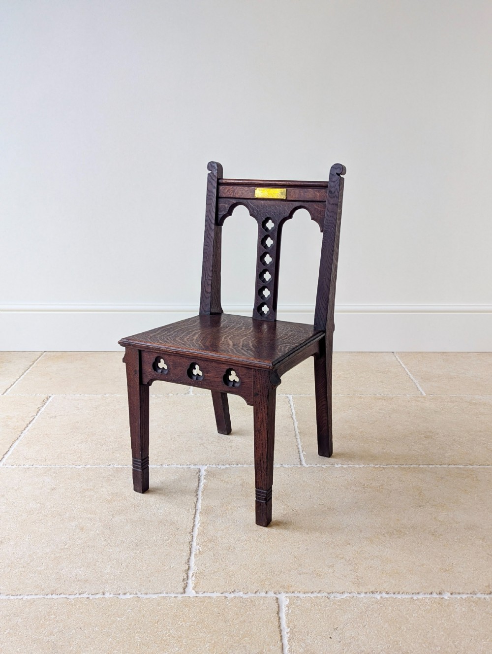 A pair of dark oak Edwardian Gothic Revival side chairs displaying trefoil cutouts, pointed arches, and solid square legs. View VIII