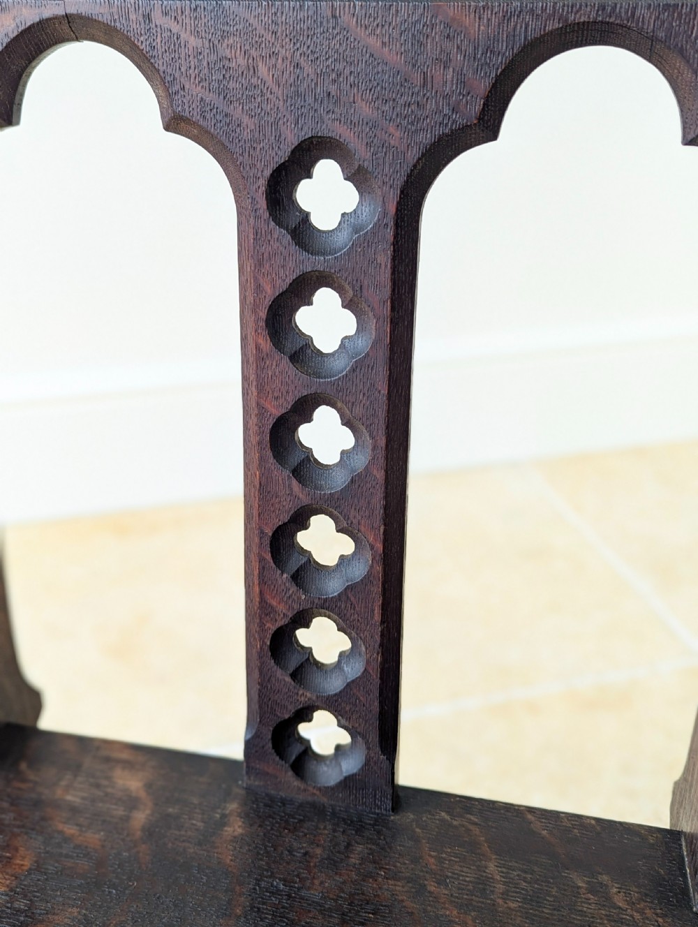 A pair of dark oak Edwardian Gothic Revival side chairs displaying trefoil cutouts, pointed arches, and solid square legs. View XII