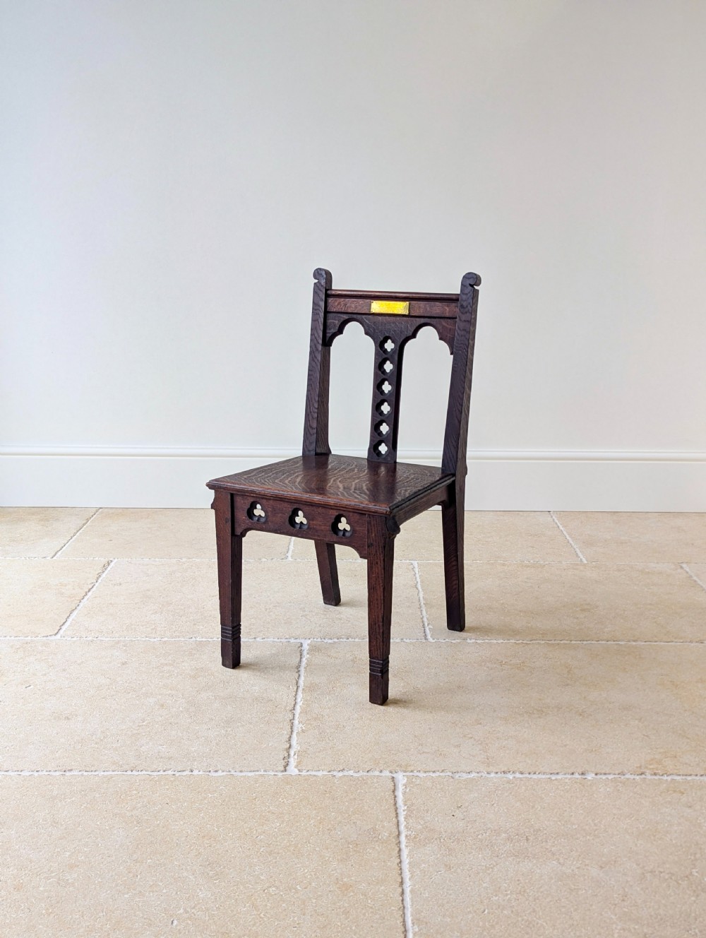 A pair of dark oak Edwardian Gothic Revival side chairs displaying trefoil cutouts, pointed arches, and solid square legs. View XIII