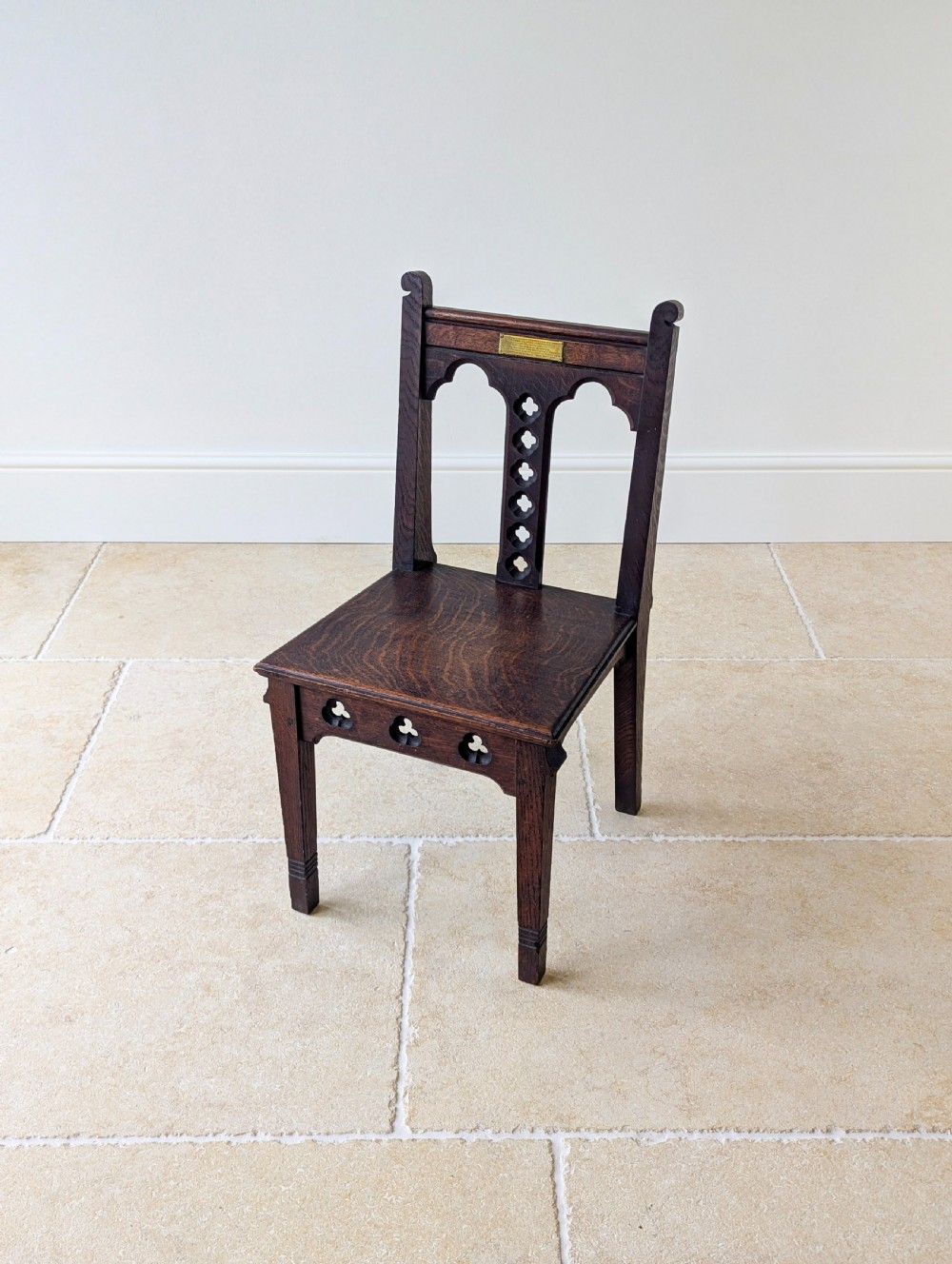 A pair of dark oak Edwardian Gothic Revival side chairs displaying trefoil cutouts, pointed arches, and solid square legs. View XV