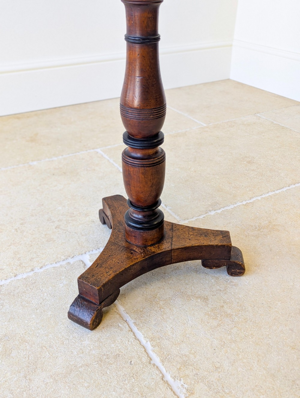 An antique mahogany music stand featuring a lyre-shaped sheet rest, dual brass candle sconces, a turned stem, and a carved tripod base. View XI