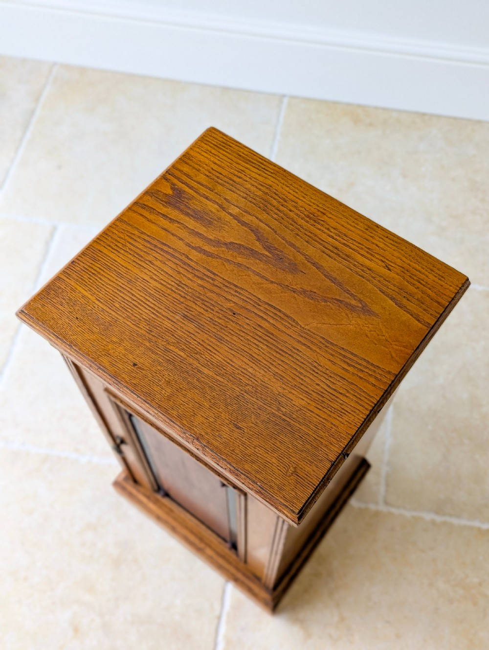 A late Victorian Aesthetic Movement oak bedside cabinet featuring an ebonised inset panel door and drop ring handle. View IV