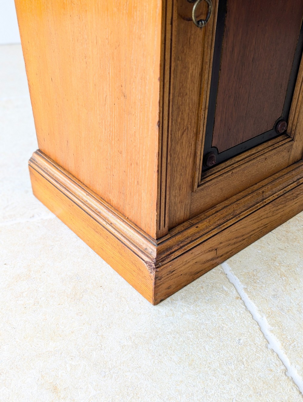A late Victorian Aesthetic Movement oak bedside cabinet featuring an ebonised inset panel door and drop ring handle. View XIII