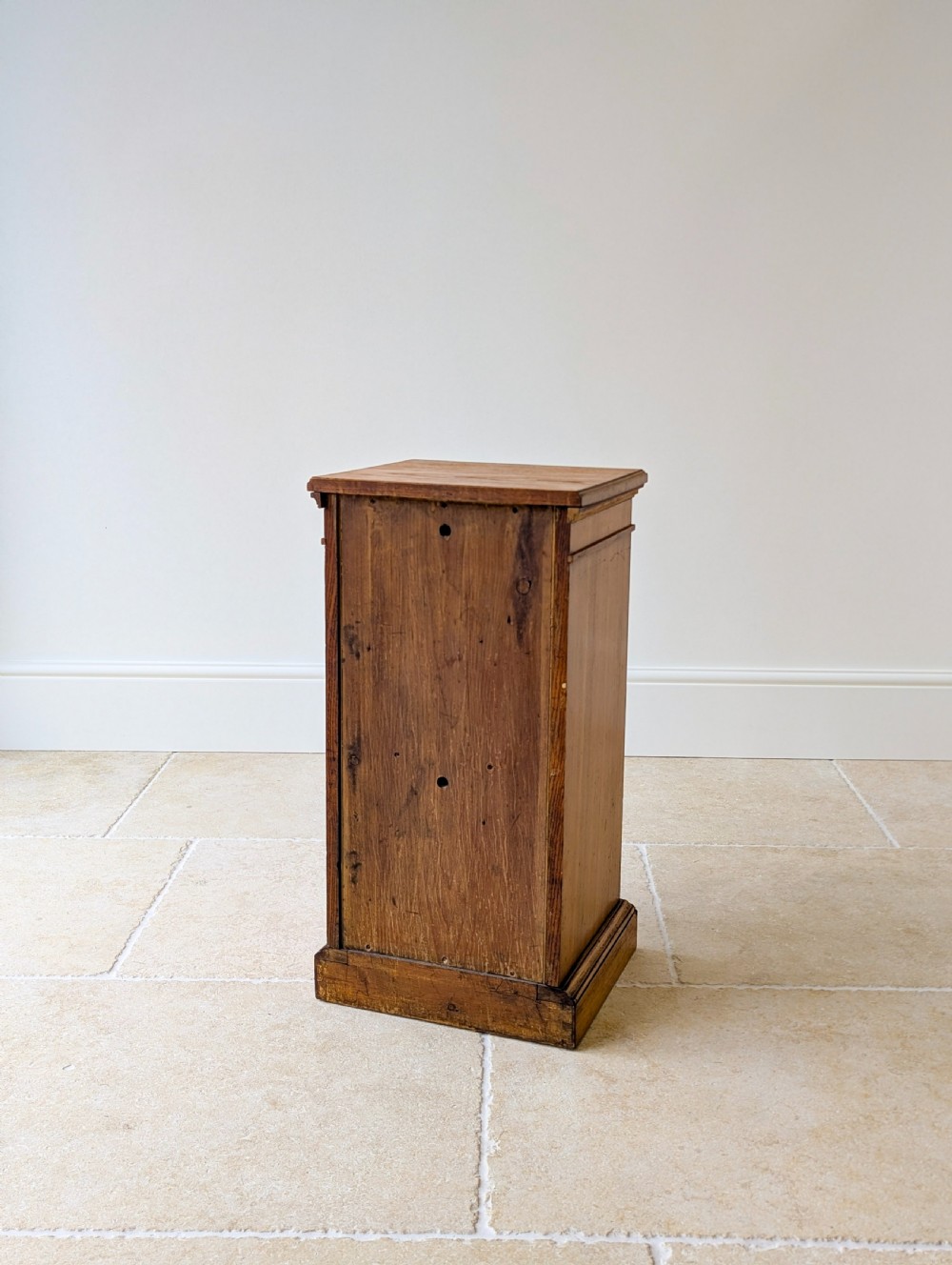A late Victorian Aesthetic Movement oak bedside cabinet featuring an ebonised inset panel door and drop ring handle. View XV