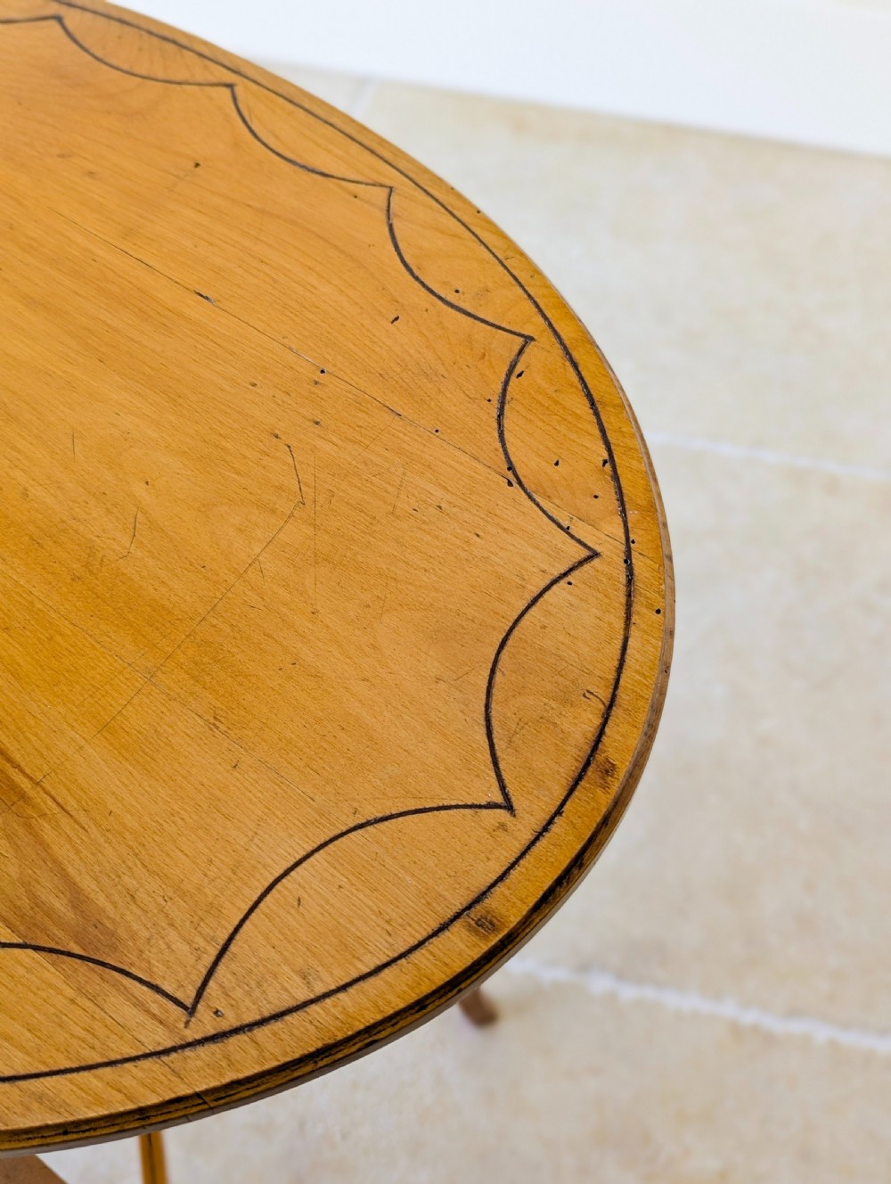 An Edwardian oval satinwood occasional table featuring delicate marquetry inlay on the top, slender splayed legs, and a small oval undertier. View XVII