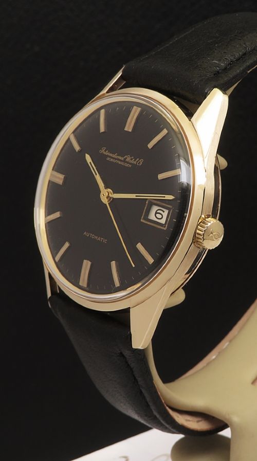 fig 2. A vintage 1960s IWC wristwatch featuring a solid gold case, a black dial with gold baton hour markers, and a black leather strap.