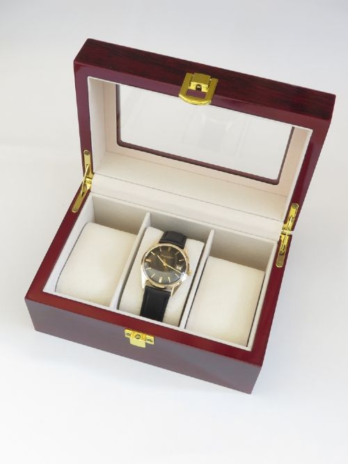 A vintage 1960s IWC wristwatch featuring a solid gold case, a black dial with gold baton hour markers, and a black leather strap. View IX